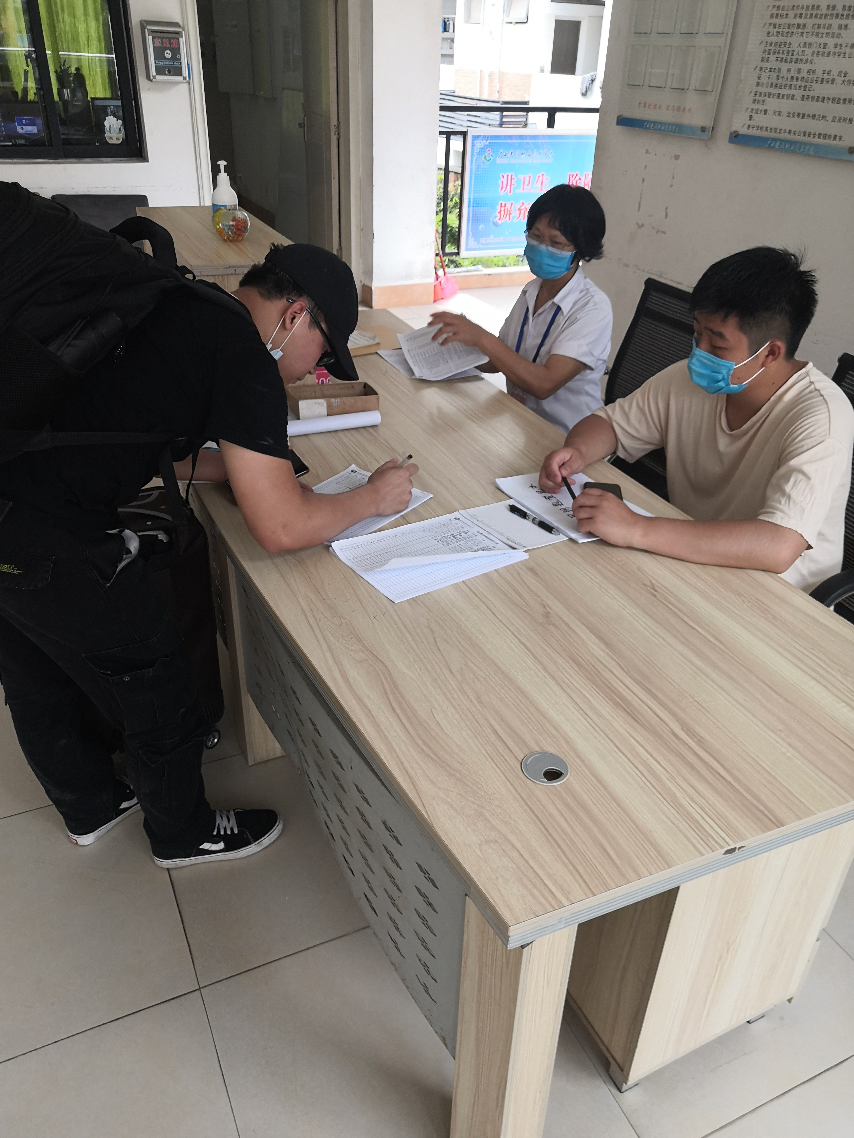 自管会委员们在公寓门厅协助入住工作